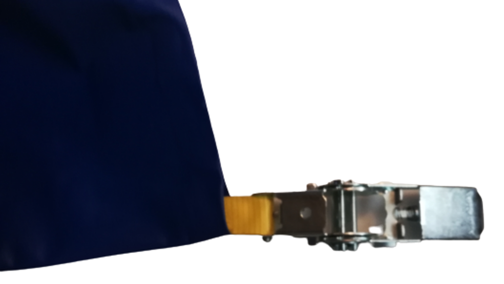 Ratchet tensioner on a webbing strap at the edge of a PVC boat cover